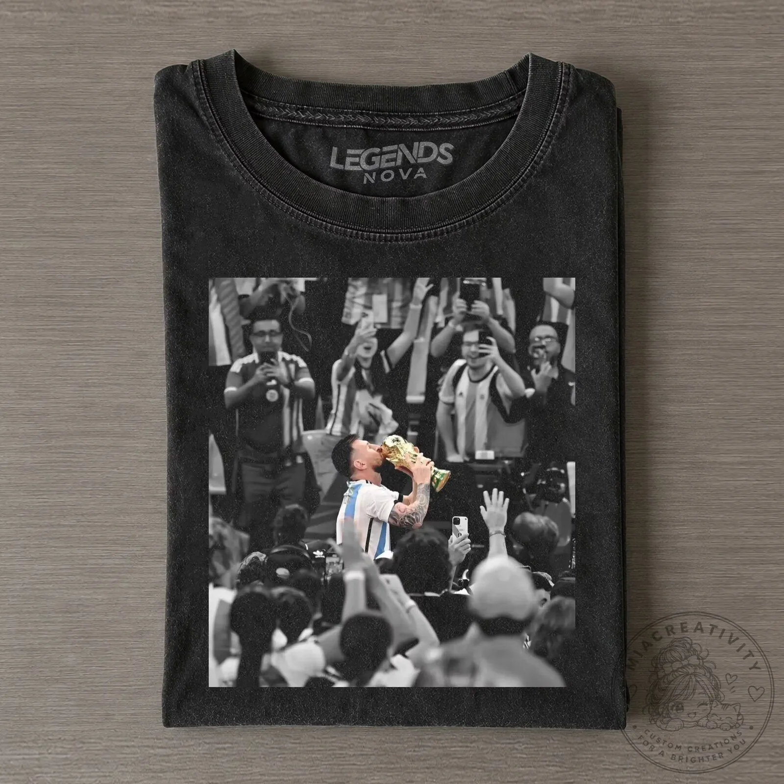 Graphic T-Shirt Featuring Lionel Messi Kissing the World Cup Trophy Champion Design